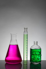 Liquid in laboratory bottles. Scientific biochemical laboratory. Colorful liquid.