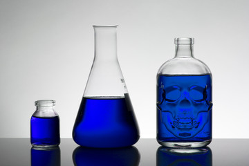 Liquid in laboratory bottles. Scientific biochemical laboratory. Colorful liquid.