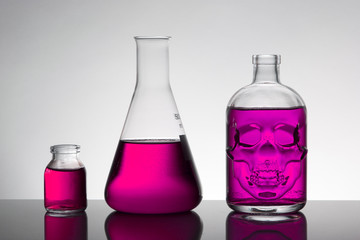 Liquid in laboratory bottles. Scientific biochemical laboratory. Colorful liquid.