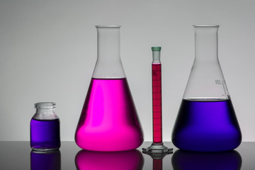 Liquid in laboratory bottles. Scientific biochemical laboratory. Colorful liquid.