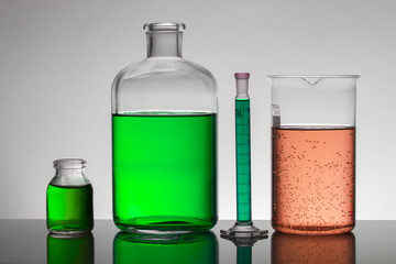 Liquid in laboratory bottles. Scientific biochemical laboratory. Colorful liquid.