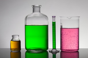 Liquid in laboratory bottles. Scientific biochemical laboratory. Colorful liquid.