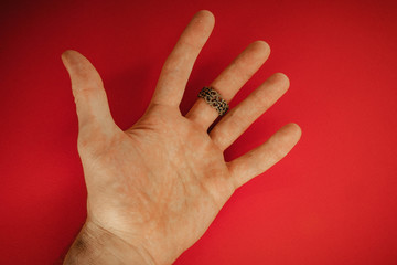 ring on hand on red background