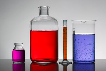 Liquid in laboratory bottles. Scientific biochemical laboratory. Colorful liquid.