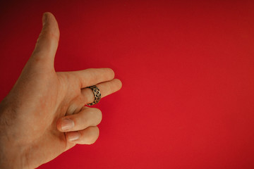 Fototapeta na wymiar ring on hand on red background
