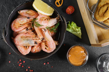 Beer mug, grilled shrimps, sausages and pretzel on wooden table. Top view