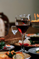 A glass of red wine on the table before dinner
