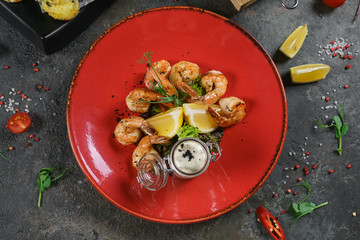 Beer mug, grilled shrimps, sausages and pretzel on wooden table. Top view