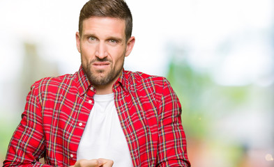 Handsome man wearing casual shirt In hurry pointing to watch time, impatience, upset and angry for deadline delay