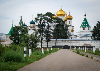 Fototapeta na wymiar Ipativsky monastery - beautiful old architecture of russian orthodoxy church. Russia, town Kostroma. Summer, green trees
