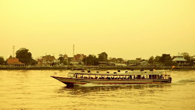Public transport boats in the Chao Phraya River, Thailand Evening travel after working hours with sunset light