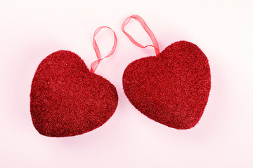 Valentine's Day composition on pastel pink background. Scenery in the form of two red...