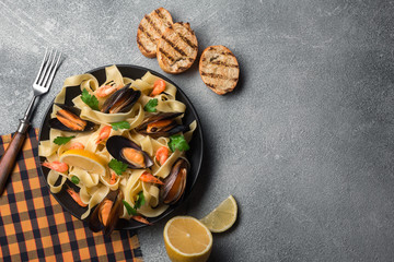 Traditional italian seafood pasta with clams Spaghetti alle Vongole on stone background