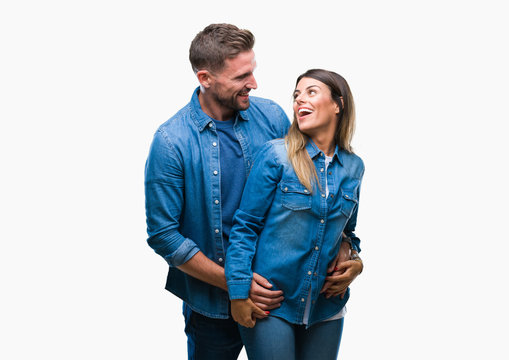 Young Couple In Love Over Isolated Background Looking Away To Side With Smile On Face, Natural Expression. Laughing Confident.