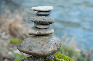 Fototapeta na wymiar Closeup of stone balance on rock in border river