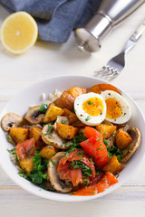 Healthy food bowl: salmon, eggs, potatoes, mushrooms, rice and spinach on white wooden table. vertical