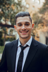 Portrait of Smiling Man with suit walking in garden