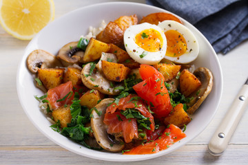 Healthy food bowl: salmon, eggs, potatoes, mushrooms, rice and spinach on white wooden table. horizontal