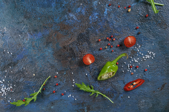Selection of spices herbs and greens. Ingredients for cooking. Food background on blue nable. Top view copy space.
