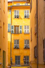 Nice, narrow street in the Vieux Nice, ancient buildings, typical facades in the old town, French Riviera