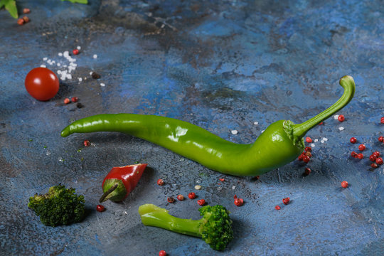 Selection of spices herbs and greens. Ingredients for cooking. Food background on blue nable. Top view copy space.