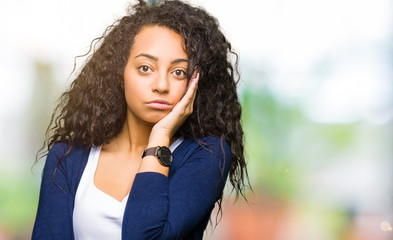 Young beautiful girl with curly hair thinking looking tired and bored with depression problems with crossed arms.