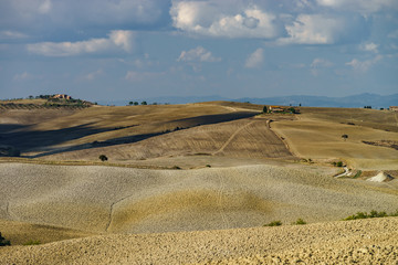 Autumn in Italy. Yellow plowed hills of Tuscany with interesting shadows and lines