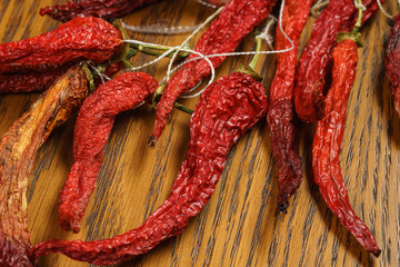 red hot chillies pepper bunch in wooden bowl background, shallow dof