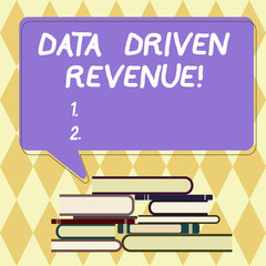 Text sign showing Data Driven Revenue. Conceptual photo makes strategic decisions based analysis interpretation Uneven Pile of Hardbound Books and Blank Rectangular Color Speech Bubble