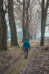 Young man walking in the forest