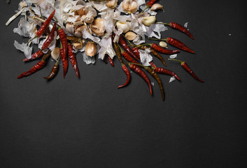 Red hot chili peppers and garlic, on sackcloth, on wooden background