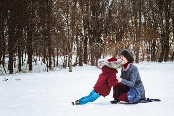 Fototapeta premium girl with mom playing in winter 2