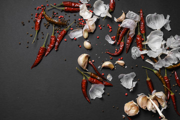 Red hot chili peppers and garlic, on sackcloth, on wooden background