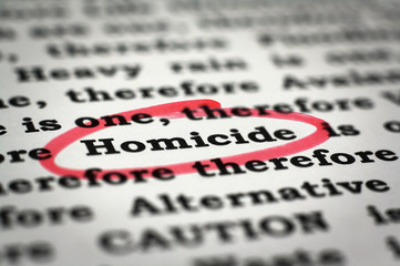 Newspaper with focus on the red marked word homicide