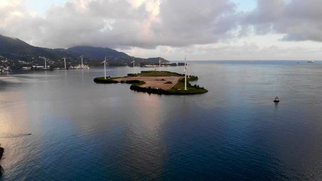 Aerial video from the drone on the island of Mahe. Beautiful bird's-eye view of the ocean. Sunset and sunrise on the paradise island of Eden. Windmill.