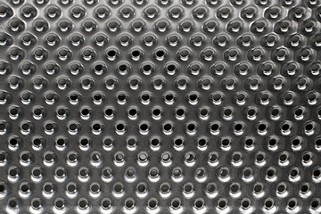 Surface of steel inner drum of washing machine. Metal with holes