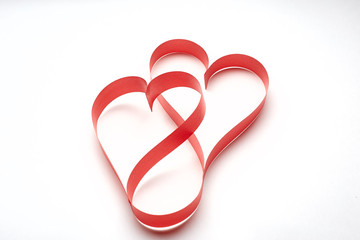 Red heart ribbon on white background