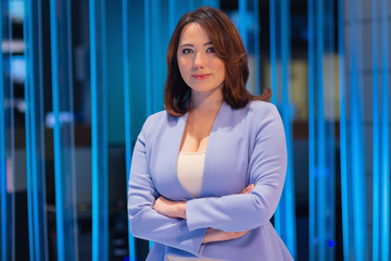Beautiful woman in a television studio. People