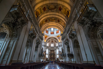 Fototapeta na wymiar Salzburg, Austria - October, 07, 2018 - Tourists visit the interior of the Salzburg Cathedral.