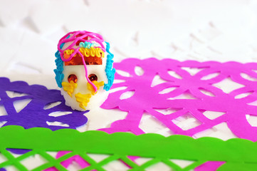 sugar skull on white purple green and pink perforated paper