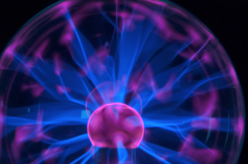 Plasma ball with moving light beams. Tesla coil with plasma in the flask.