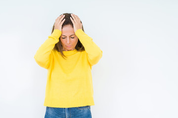 Beautiful middle age woman wearing yellow sweater over isolated background suffering from headache desperate and stressed because pain and migraine. Hands on head.