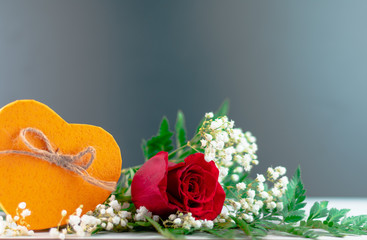 Corazón amarillo con rosa, cinta roja en un fondo oscuro