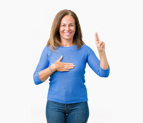 Middle age beautiful woman wearing winter sweater over isolated background Swearing with hand on...