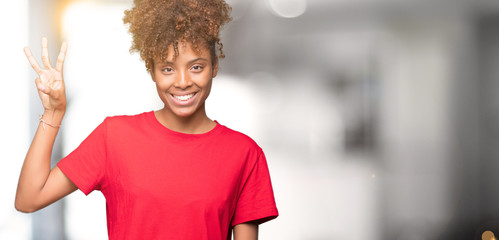 Beautiful young african american woman over isolated background showing and pointing up with fingers number three while smiling confident and happy.