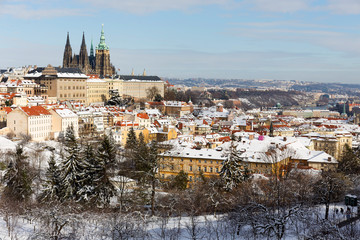 Obraz premium Snowy Prague City with gothic Castle from Hill Petrin in the sunny Day, Czech republic