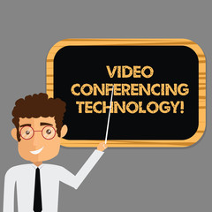 Text sign showing Video Conferencing Technology. Conceptual photo People globally interacted through video data Man Standing Holding Stick Pointing to Wall Mounted Blank Color Board