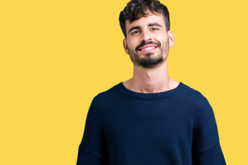 Fototapeta premium Young handsome man over isolated background Hands together and fingers crossed smiling relaxed and cheerful. Success and optimistic