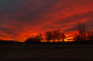 Fototapeta na wymiar As day breaks the sky turns a gorgeous fiery red in Missouri.