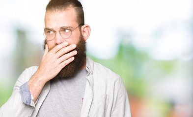 Fototapeta premium Young blond man wearing glasses looking stressed and nervous with hands on mouth biting nails. Anxiety problem.